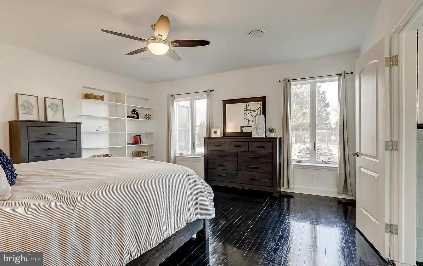 8040 Leishear Road Laurel, MD 20723 - Photo 33 of 66 a spacious bedroom with a bed and wooden floor