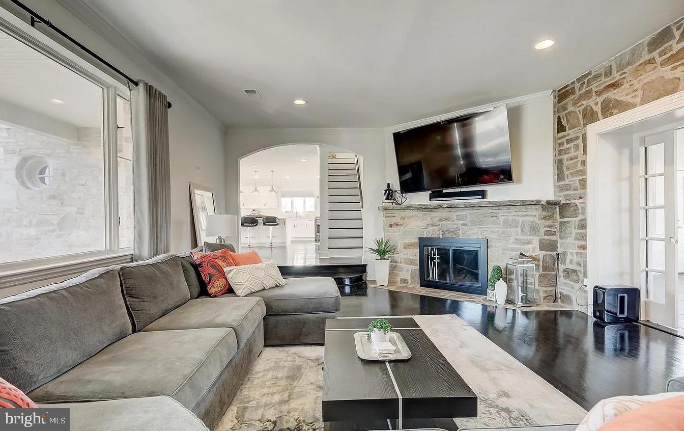 8040 Leishear Road Laurel, MD 20723 - Photo 34 of 66 a living room with furniture a flat screen tv and a fireplace
