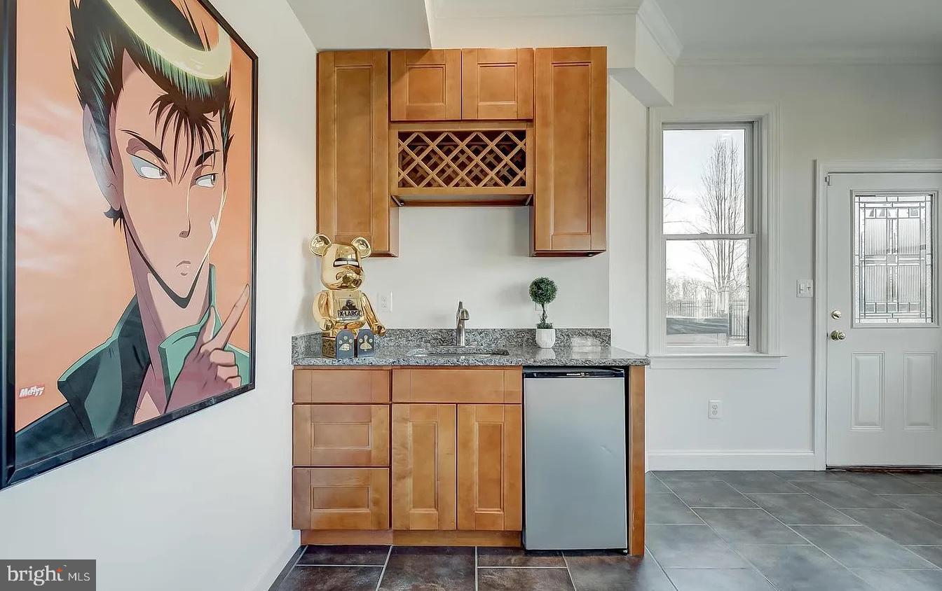 8040 Leishear Road Laurel, MD 20723 - Photo 35 of 66 a kitchen with granite countertop a stove and a sink