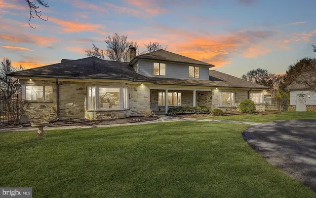 a view of a living room with a table and chairs