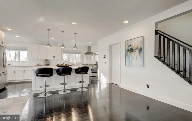 a kitchen with granite countertop white cabinets and white appliances