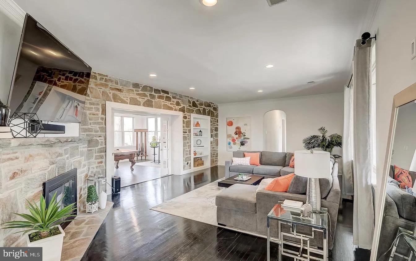8040 Leishear Road Laurel, MD 20723 - Photo 50 of 66 a living room with furniture a fireplace and a flat screen tv