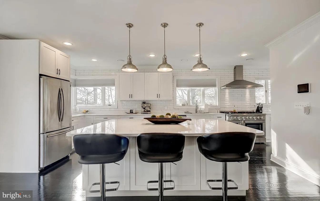 8040 Leishear Road Laurel, MD 20723 - Photo 51 of 66 a kitchen with stainless steel appliances kitchen island granite countertop a dining table chairs and sink