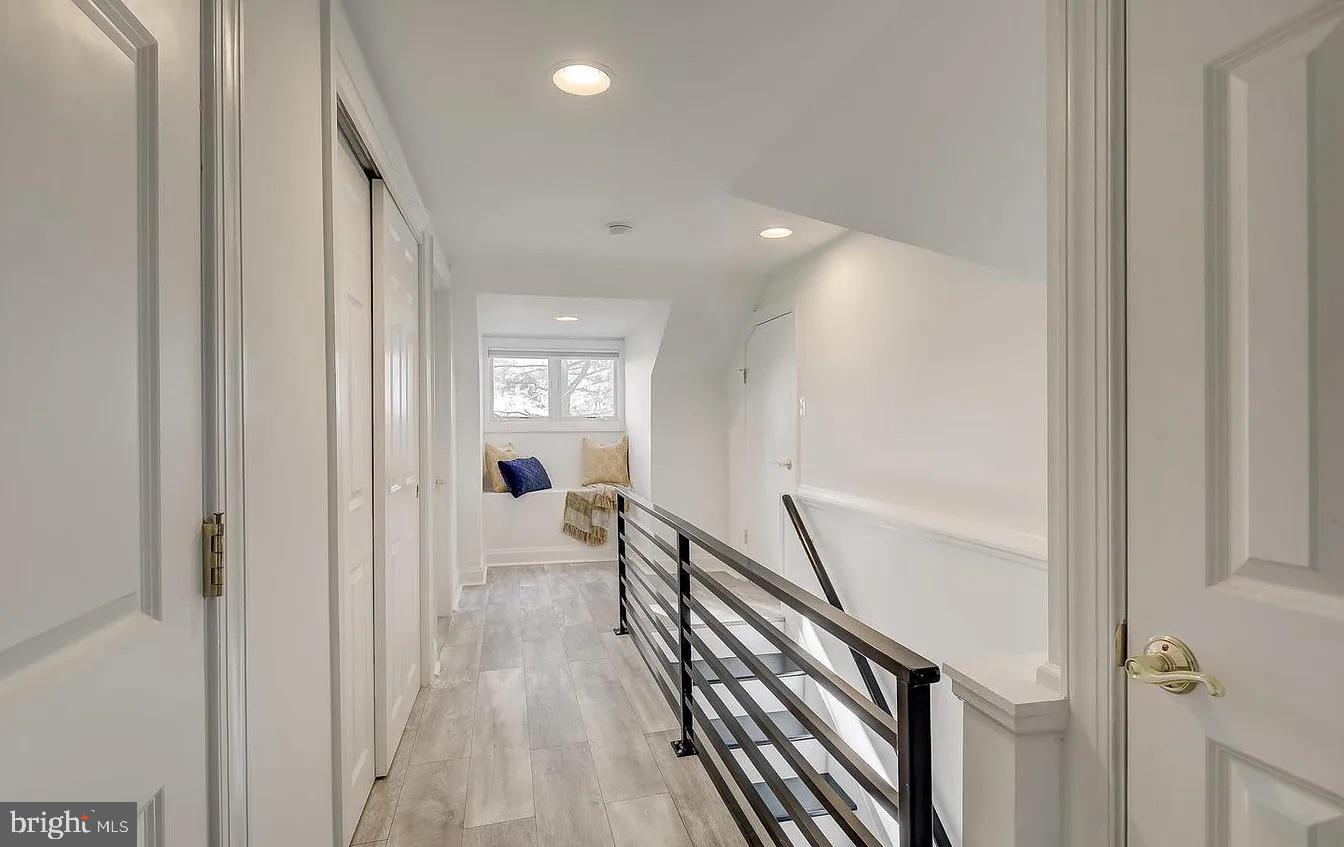 8040 Leishear Road Laurel, MD 20723 - Photo 52 of 66 a view of a hallway with wooden floor and stairs