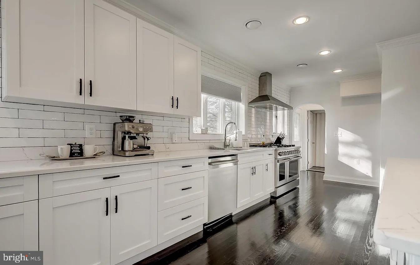 8040 Leishear Road Laurel, MD 20723 - Photo 54 of 66 a kitchen with granite countertop white cabinets and white appliances