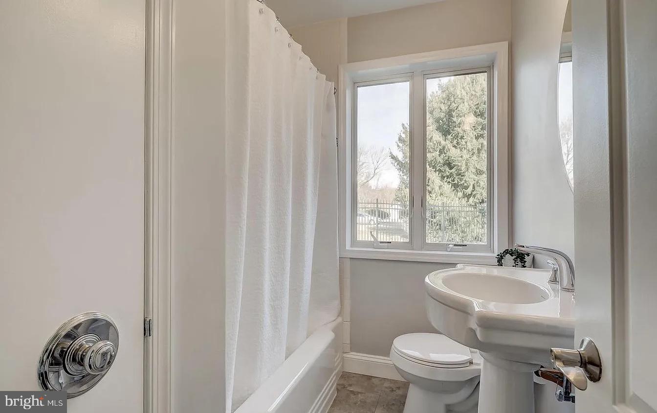 8040 Leishear Road Laurel, MD 20723 - Photo 59 of 66 a bathroom with a toilet a sink and a window