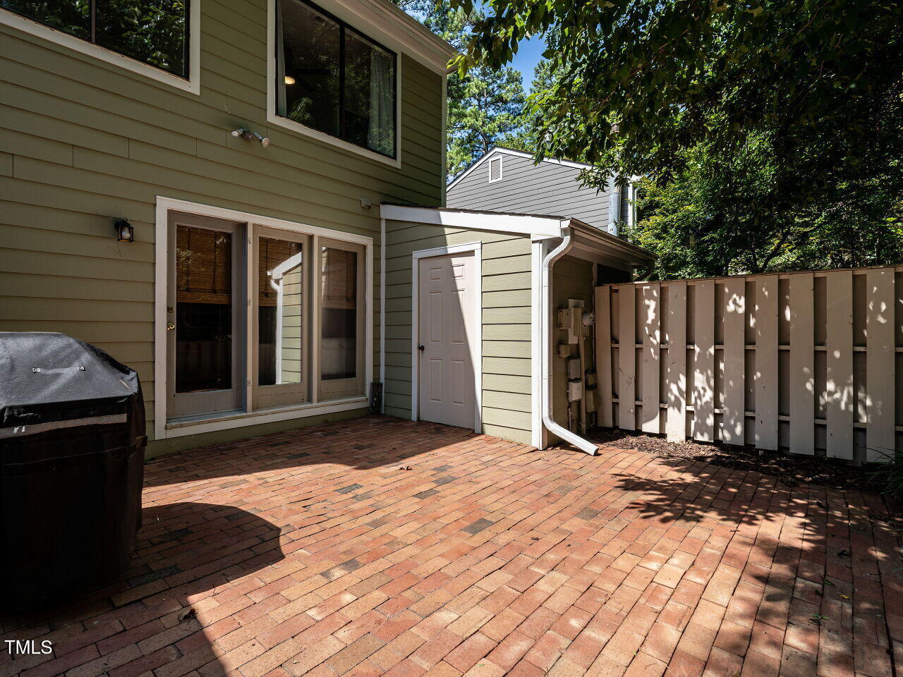 837 Green Ridge Drive Raleigh, NC 27609 - Photo 27 of 29 a view of backyard with small cabin and wooden fencing