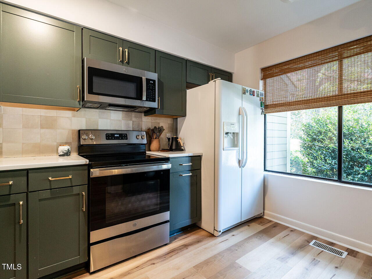 837 Green Ridge Drive Raleigh, NC 27609 - Photo 6 of 29 a kitchen with a refrigerator stove and microwave
