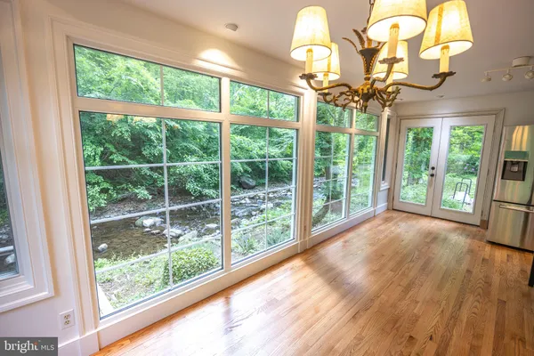 a view of a room with wooden floor and windows