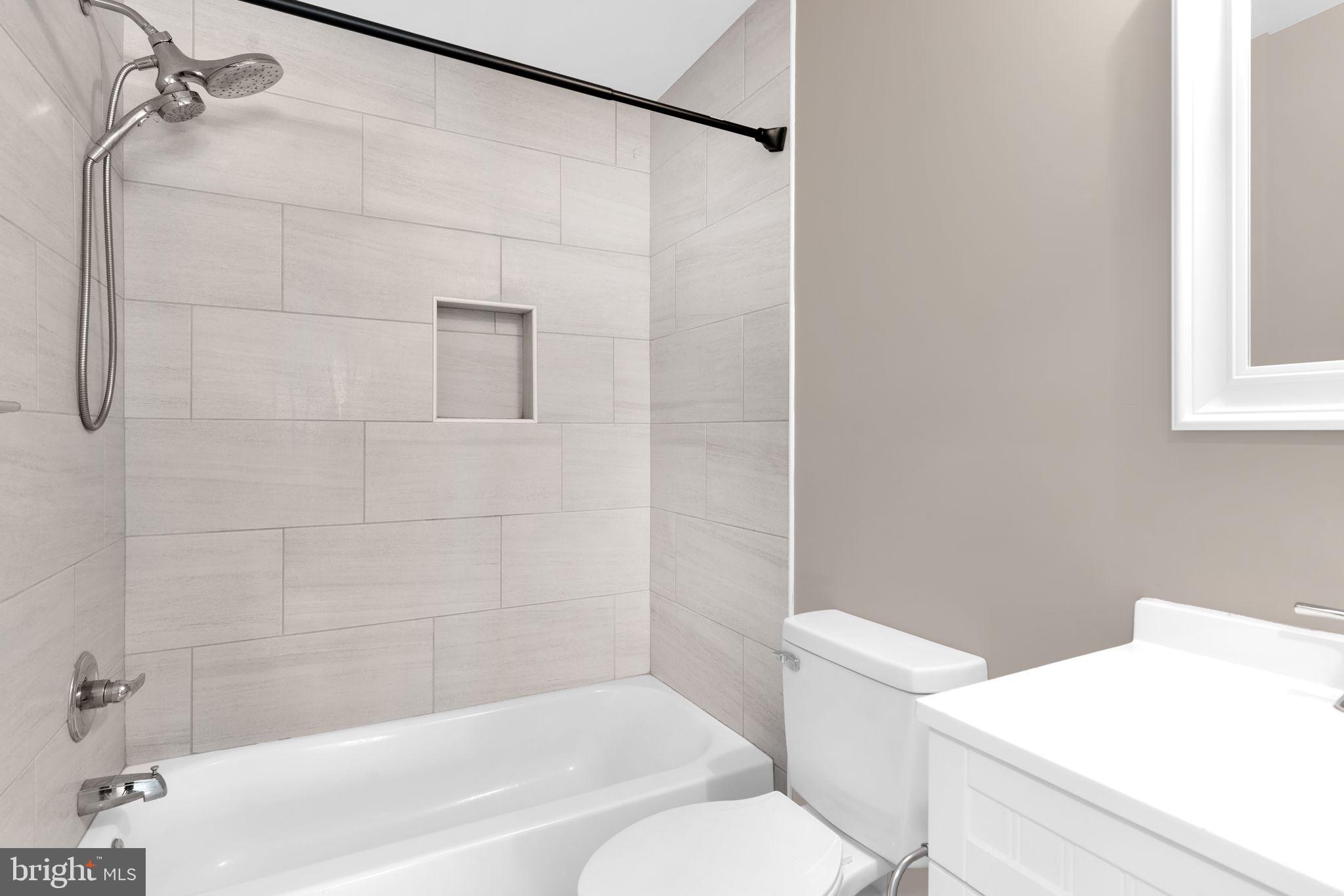 383 Sollers Wharf Road, Unit A Lusby, MD 20657 - Photo 12 of 16 a bathroom with a sink a toilet and shower