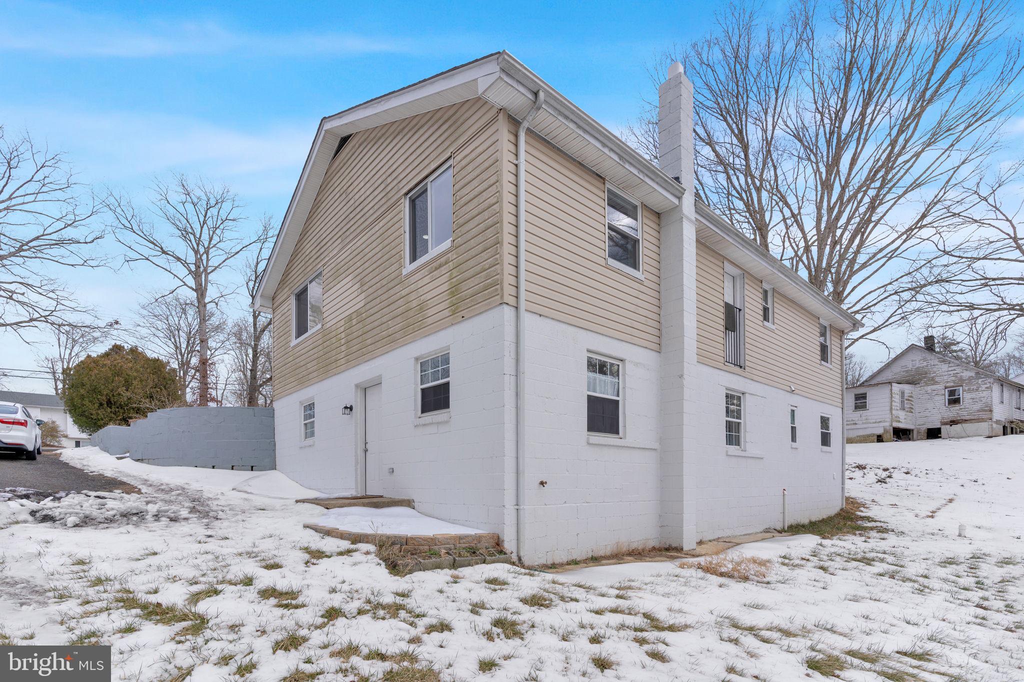 383 Sollers Wharf Road, Unit A Lusby, MD 20657 - Photo 13 of 16 a view of a white house with a yard