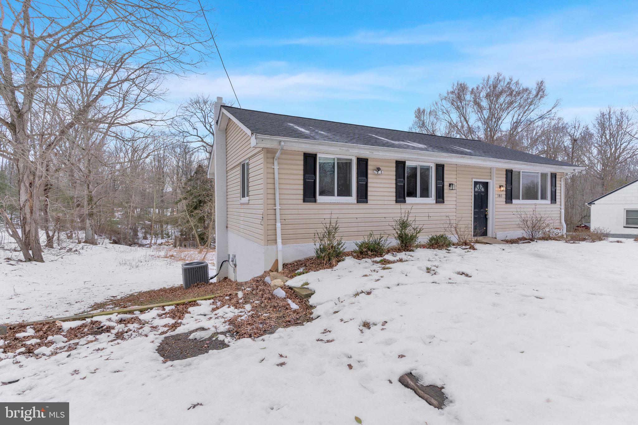 383 Sollers Wharf Road, Unit A Lusby, MD 20657 - Photo 15 of 16 a front view of a house with a yard