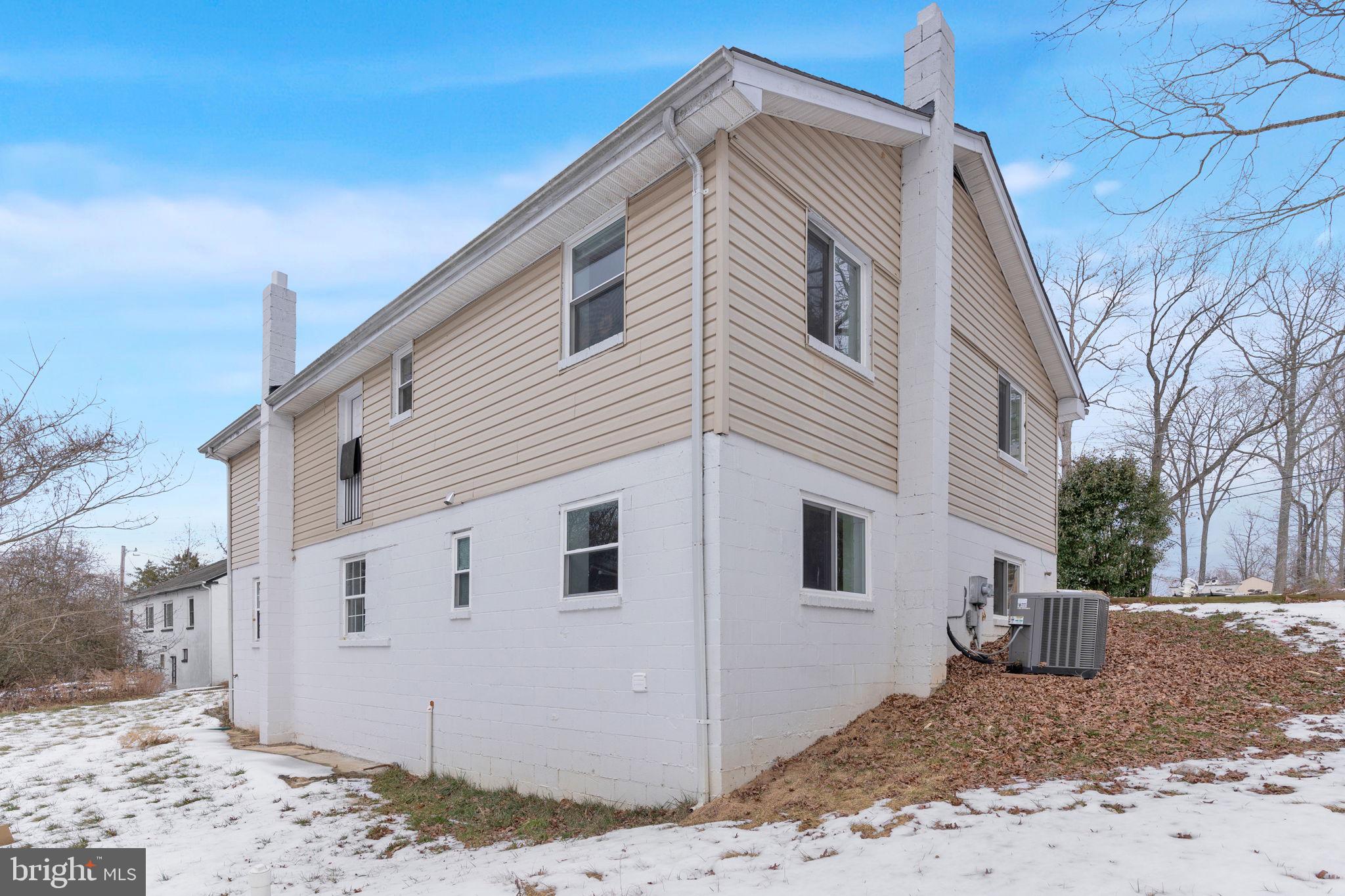 383 Sollers Wharf Road, Unit A Lusby, MD 20657 - Photo 16 of 16 a view of a house with a backyard