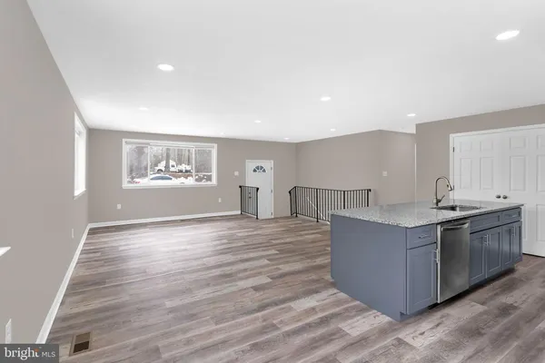 a view of kitchen with cabinets and wooden floor