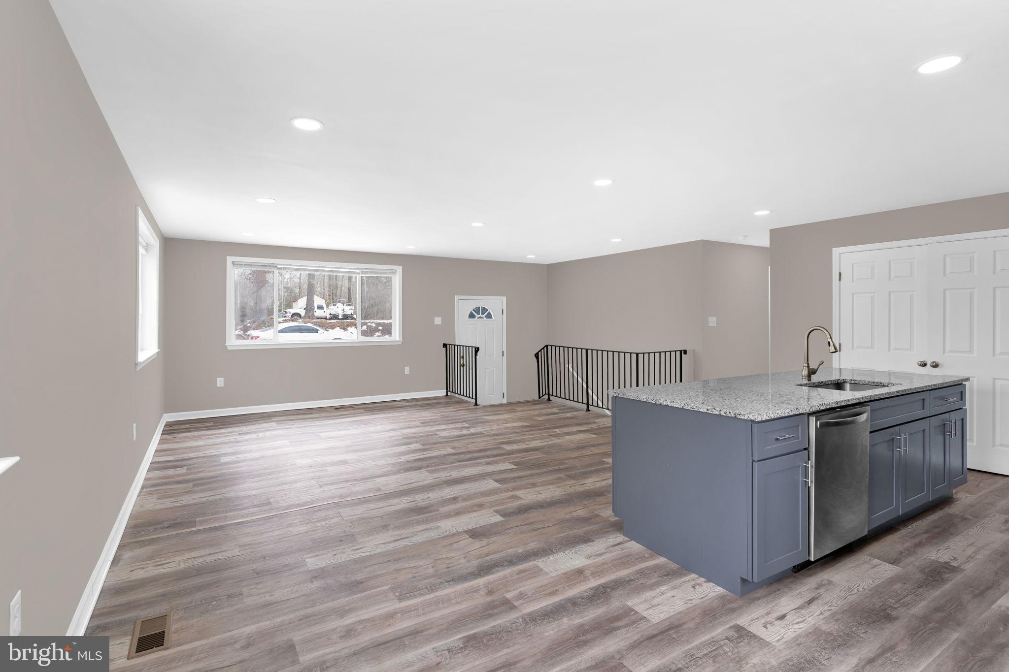 383 Sollers Wharf Road, Unit A Lusby, MD 20657 - Photo 3 of 16 a view of kitchen with cabinets and wooden floor