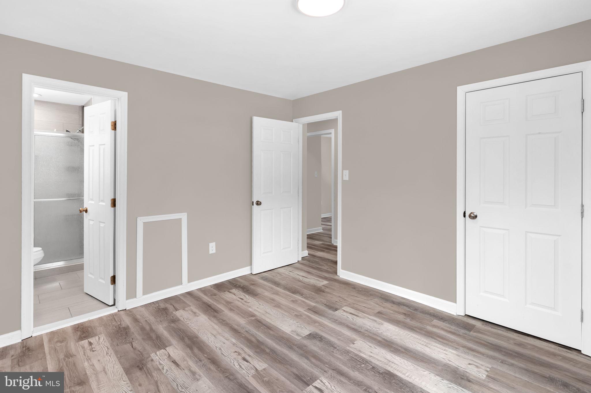 383 Sollers Wharf Road, Unit A Lusby, MD 20657 - Photo 10 of 16 a view of a room with wooden floor and a bathroom