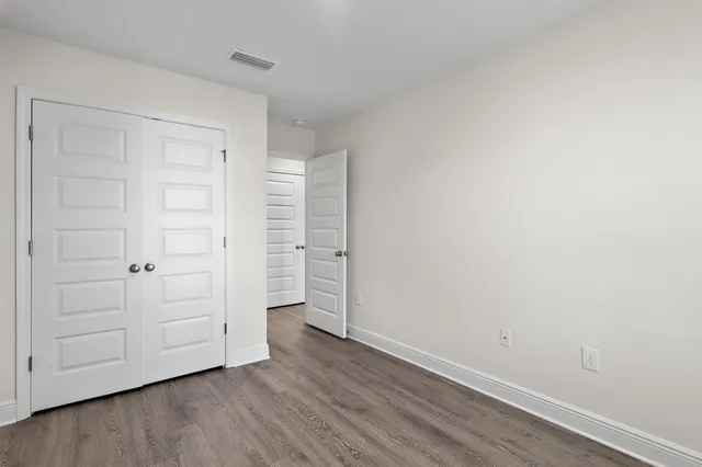 a view of an empty room and wooden floor