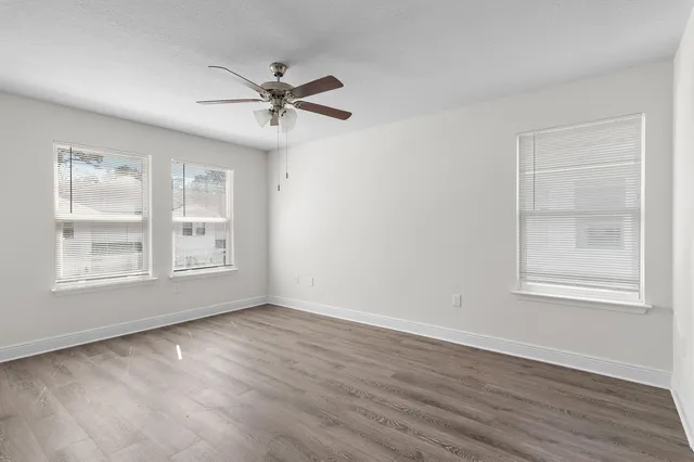 a bathroom with a granite countertop toilet a sink and a bathtub