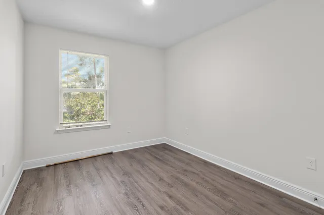 a view of an empty room and wooden floor