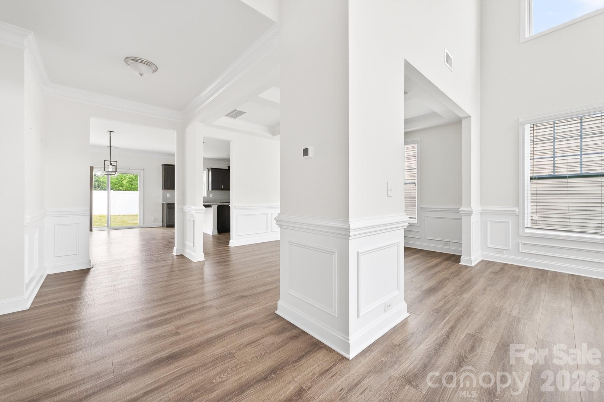 5972 Redwood Pine Road Concord, NC 28027 - Photo 7 of 37 a view of a kitchen with wooden floor and a refrigerator