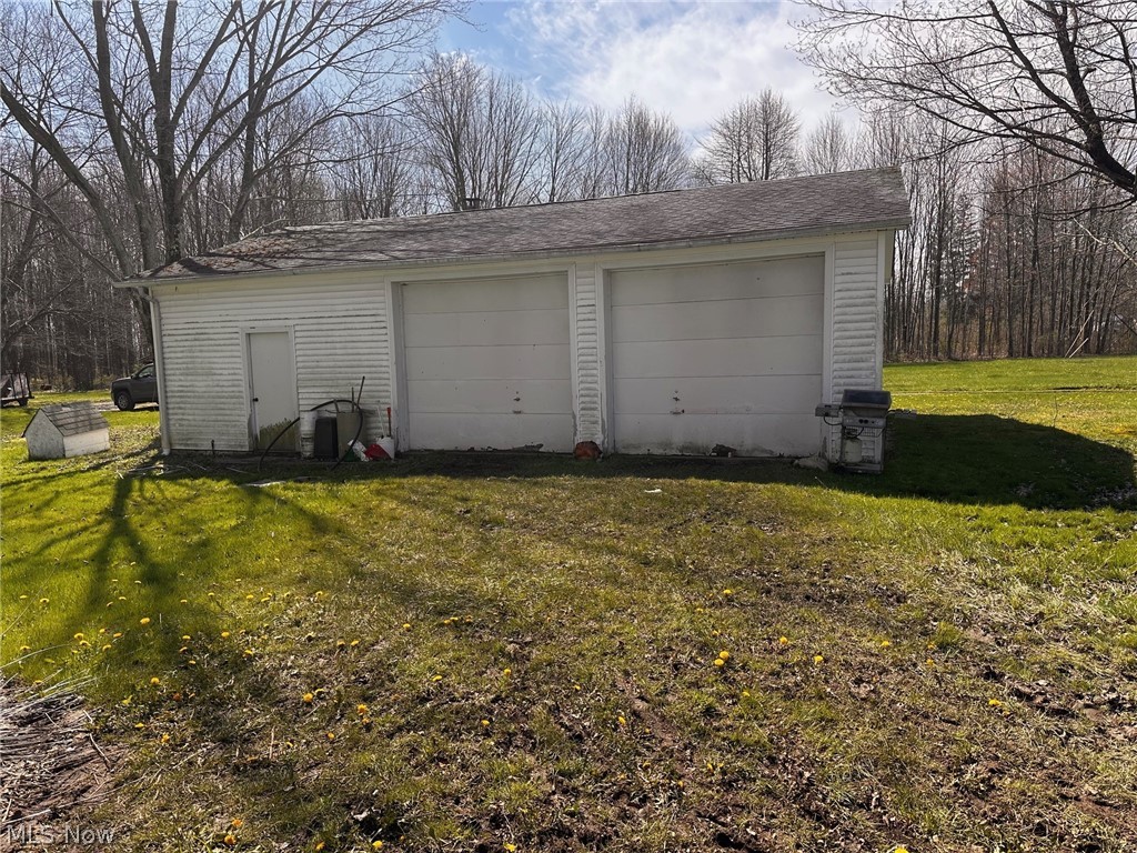 9526 Horn Road Windham, OH 44288 - Photo 2 of 14 Garage featuring a lawn