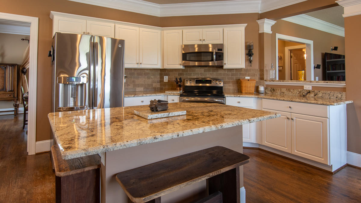 5738 North Fork Road Elliston, VA 24087 - Photo 20 of 77 a kitchen with kitchen island granite countertop a sink cabinets and stainless steel appliances