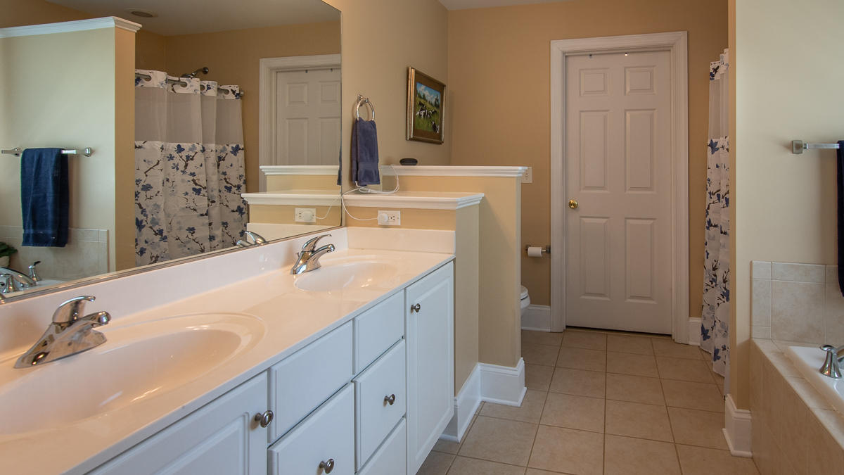 5738 North Fork Road Elliston, VA 24087 - Photo 35 of 77 a spacious bathroom with a double vanity sink a mirror and a bathtub