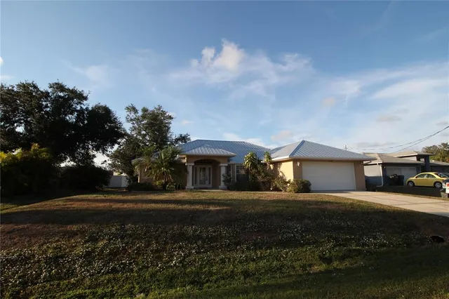 a view of a house with a yard and pathway