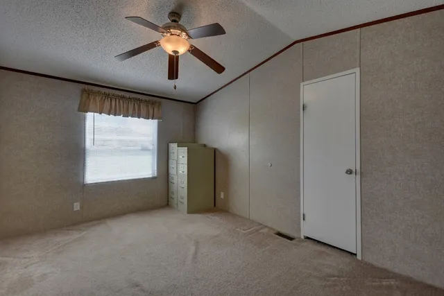 a view of a livingroom with a ceiling fan and window
