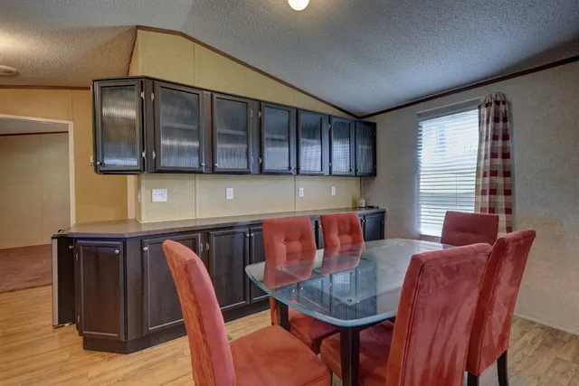 a dining room with furniture and window