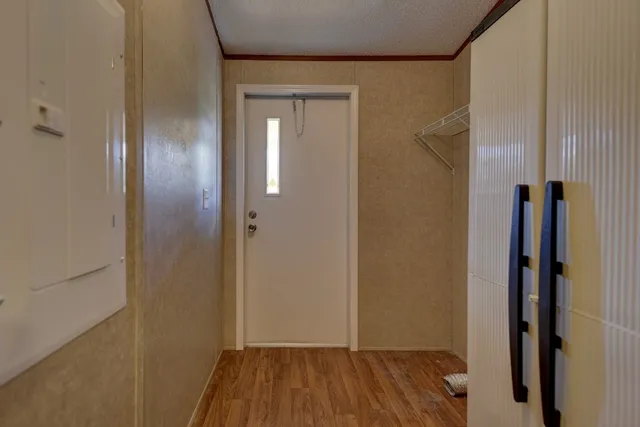 a view of a hallway with wooden floor