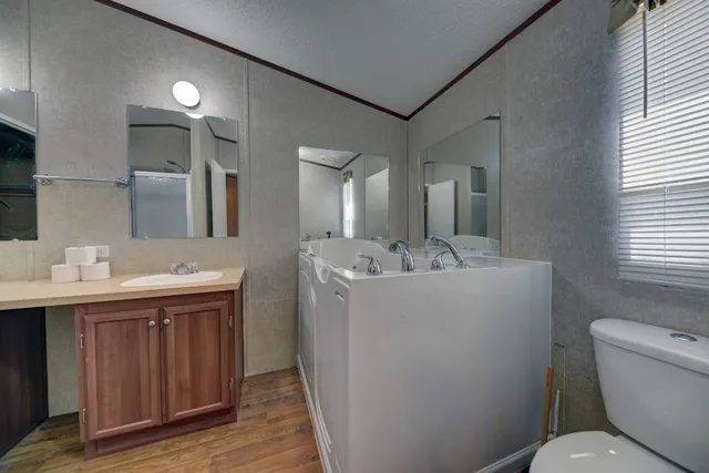 a bathroom with a toilet sink and mirror