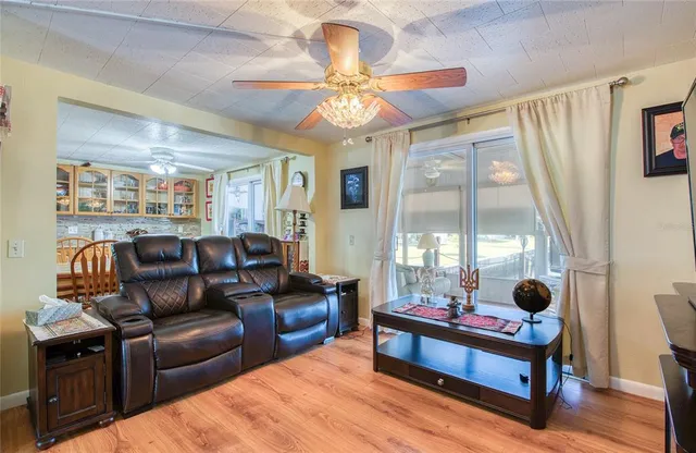 a living room with furniture fireplace and large window