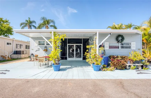 front view of a house with a couple of people seating
