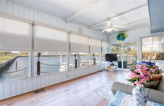 a living room with furniture wooden floor and flat screen tv