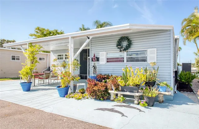 a view of a patio with dining table and chairs potted plants