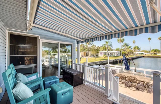 a view of a patio with table and chairs potted plants with wooden floor