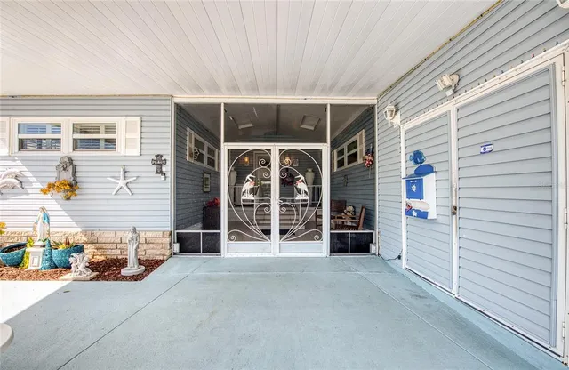 a view of a house with a barbeque and large parking space