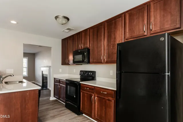 a kitchen with a refrigerator stove and microwave