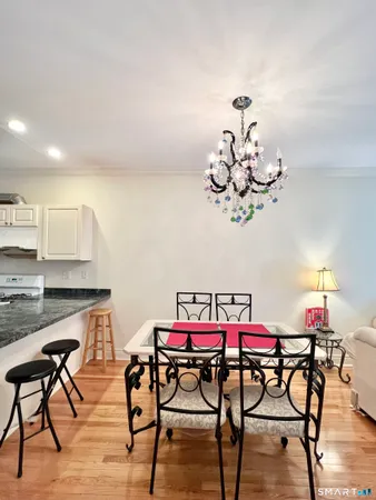 a view of a dining room with furniture and chandelier