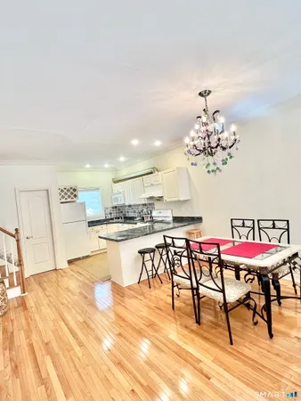 a view of a dining room with furniture and wooden floor
