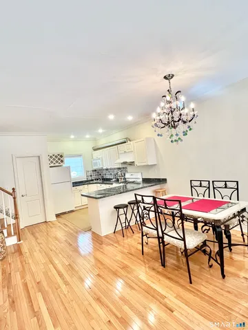 a view of a dining room with furniture and wooden floor