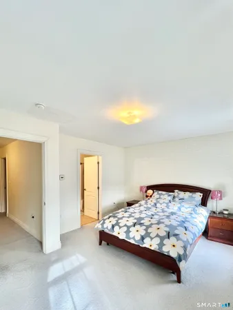 a bedroom with a bed and a night stand