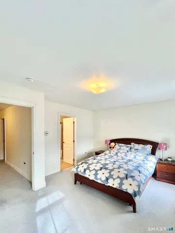 a bedroom with a bed and a night stand