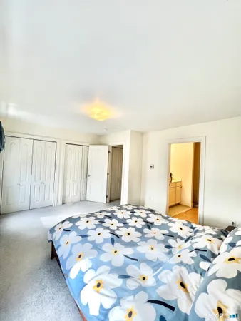 a bedroom with a bed and a couch