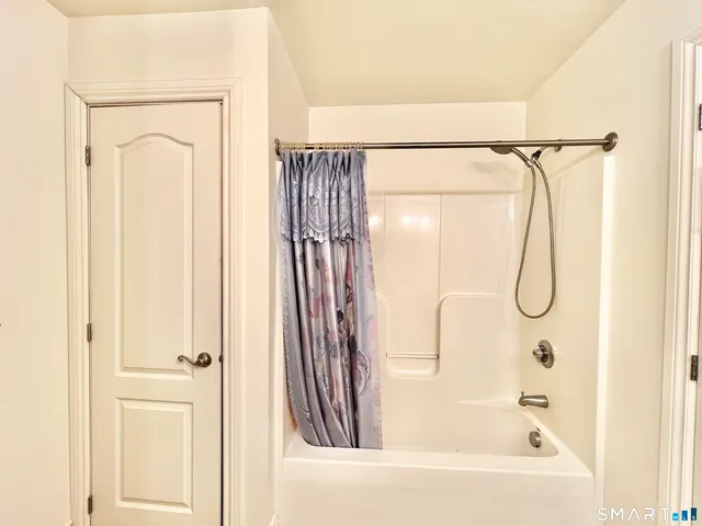 a bathroom with a glass shower door