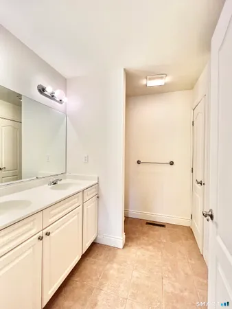 a bathroom with a granite countertop sink mirror and