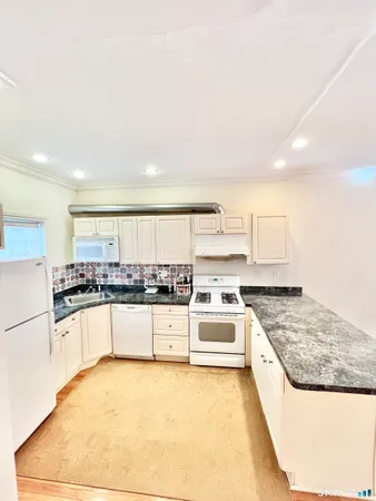 a kitchen with stainless steel appliances granite countertop a stove and a refrigerator
