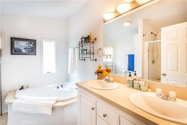 a bathroom with a tub sink and mirror
