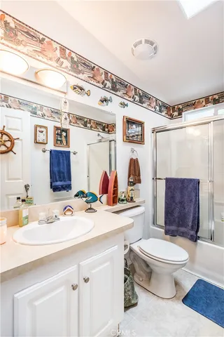 a bathroom with a sink toilet mirror and shower